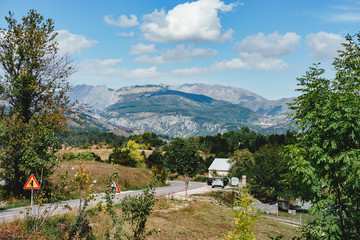 Obraz premium countryside road on a sunnyy day, mountains on the background