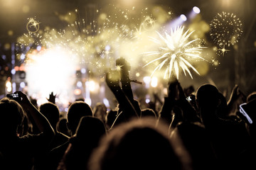 new Year concept - cheering crowd and fireworks