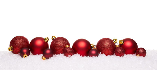 Red christmas balls isolated on snow