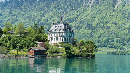 Fototapeta na wymiar Scenary from Swiss town of Iseltwald with lake Brienz near Interlaken