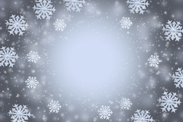 Abstract gray winter background with the snowflakes and copy space in the center.