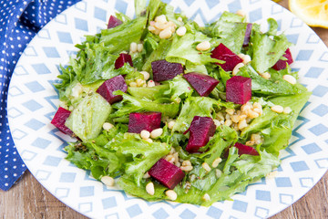 Fresh salad with beets, lettuce, pine nuts, bulgur, vegetarian summer dish