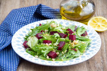 Fresh salad with beets, lettuce, pine nuts, bulgur, vegetarian summer dish
