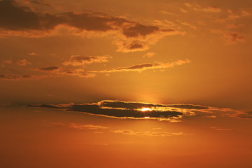 Orange sunlight behind the black cloud