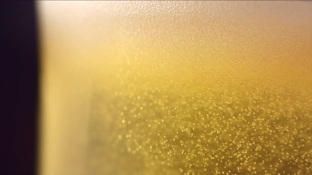 Cold beer in a glass with water drops. Closeup image. Craft beer. 4K UHD video 3840x2160