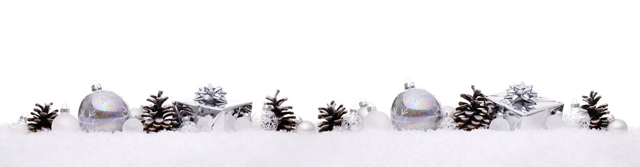 White and silver christmas balls with xmas present gift boxes in a row isolated on snow, Christmas...