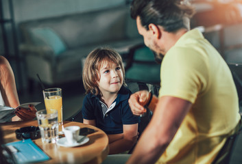 Father and son having great time in a restaurant