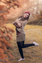 Portrait of a beautiful young woman in a red hat.