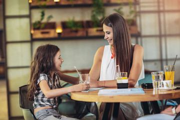 Mother and daughter having great time in a restaurant