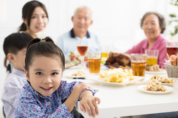 happy asian family having dinner at home