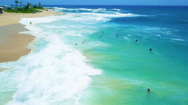 Stationary Birdseye View Of Sandy Beach Taken With A Drone.  The Turquoise Ocean Water With Aqua Colors Shows The Scenic And Dramatic Beauty Of East Oahu's Popular Surfing