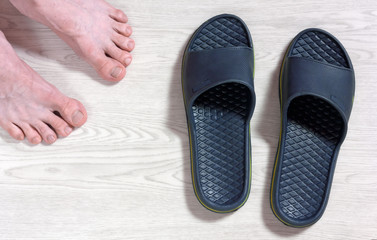 Male Bare Feet and a Pair of Flip Flops
