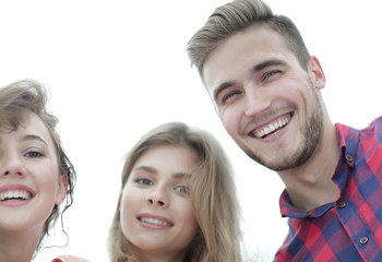 closeup of three young people smiling on white background