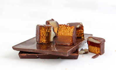 cut chocolate marzipan on chocolate bar ,  white background