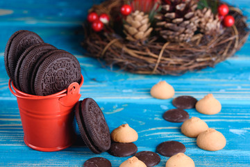 Decorative red pail with chocolate cookies on the table