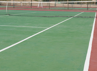Closeup of outdoor clay tennis court with net