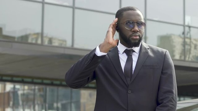 Bodyguard awaiting appearance of governmental motorcade inspecting territory