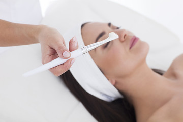 Woman with mask on her face resting in spa.