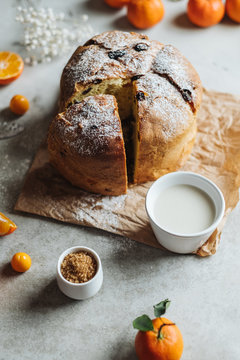 Panettone, traditional Italian Christmas cake. Close-up with sliced oranges.