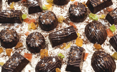 chocolate candies, candied fruits on a light background