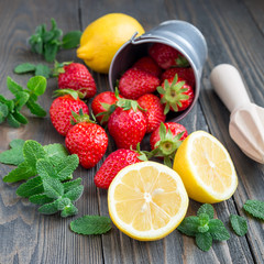 Fototapeta na wymiar Ingredients for homemade strawberry lemonade on wooden table, square format