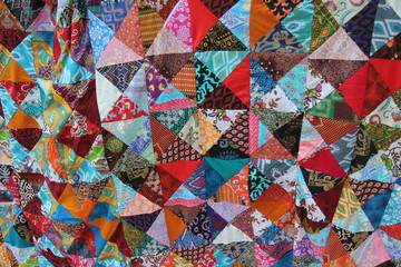 Brightly colored homemade patchwork with abstract patterns