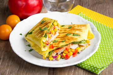 Mexican burritos with tortilla, chicken, corn, tomatoes, onion, spicy traditional dish, tasty food