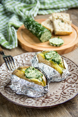 Baked potatoes with herbs butter, with green homemade butter, delicious food