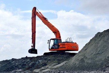 Backhoe at beach dredging site St. Augustine, Florida, USA