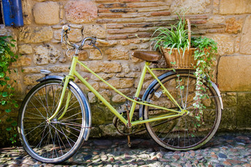 yellow bike on the background of a  half timbered house