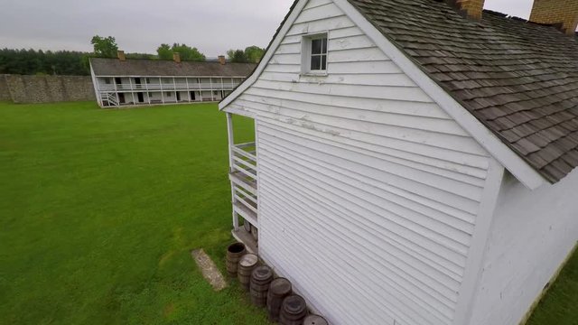 Aerial rising camera behind barracks at Fort Frederick State Park in Maryland.