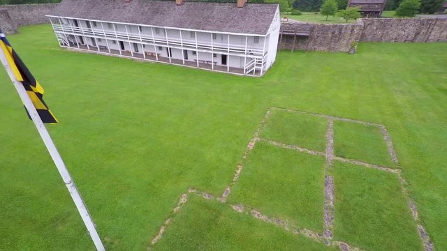 Aerial view of the Fort Frederick barracks with the Calvert Arms flag waving in the breeze.