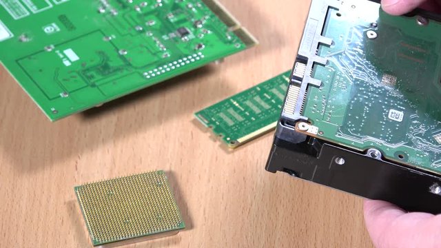 IT specialist hands examining computer hard drive component