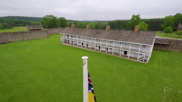 Aerial view of the Fort Frederick barracks with the Calvert Arms flag waving in the breeze.