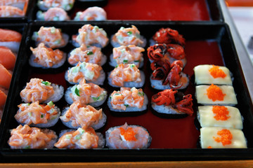 Various kinds of sushi served in street Thai market