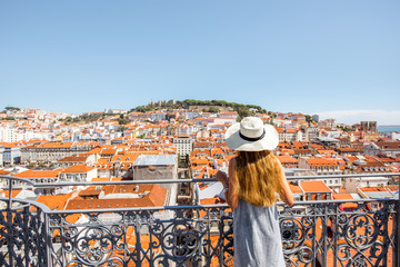 Young woman tourist enjoying beautiful cityscape top view on the old town during the sunny day in...