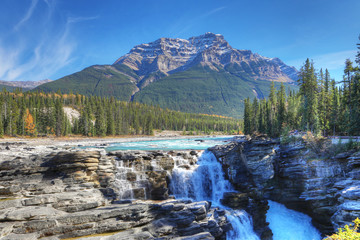 Athabasca Falls with Rocky Mountain peak behind
