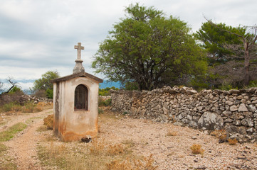 Fototapeta na wymiar Christian chapel on a picturesque road