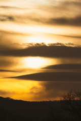 sky landscape at sunset with clouds in golden tones