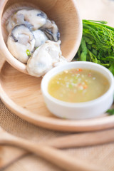 Fresh oyster on a wooden plate