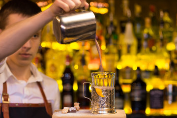 The bartender making cocktail