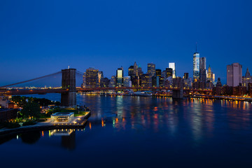 Fototapeta na wymiar Blue New York panorama with Lower Manhattan and Brooklyn bridge