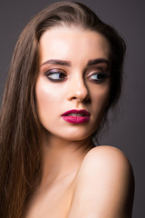 Beautiful woman with professional make up on dark background