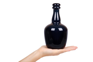 Beautiful black bottle in hand isolated on white background, expensive alcohol, luxury drink