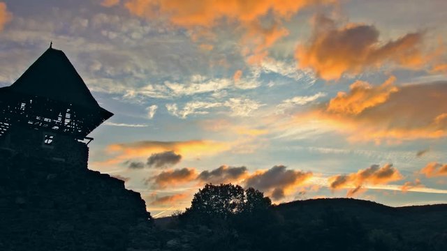 A castle Nevytsky against a pink and mauve sunset sky