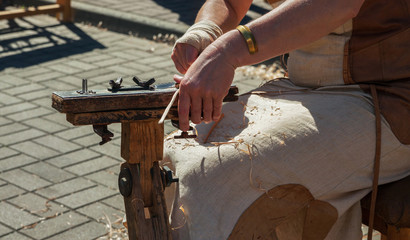 Woman braiding a basket.