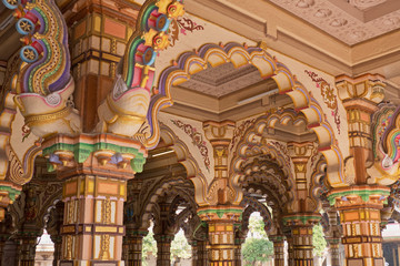 The brightly decorated Burmese teak archways in a Hindu temple in Ahmedabad, India - obrazy, fototapety, plakaty