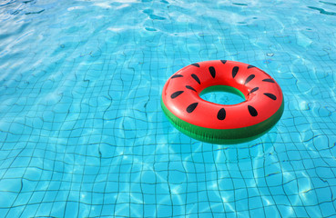 watermelon pool float, ring floating in a refreshing blue swimming pool