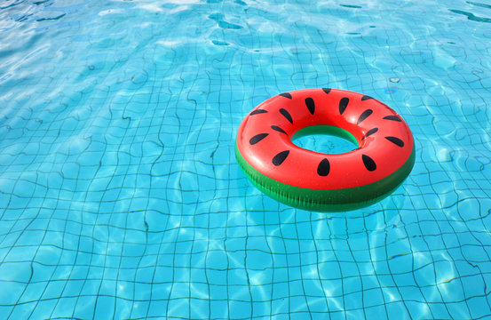 watermelon pool float, ring floating in a refreshing blue swimming pool