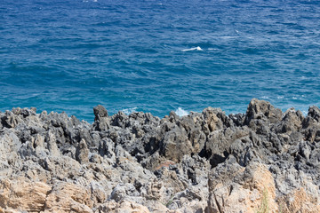 Rocky sea desert coast with stones and ocean waves at Crete